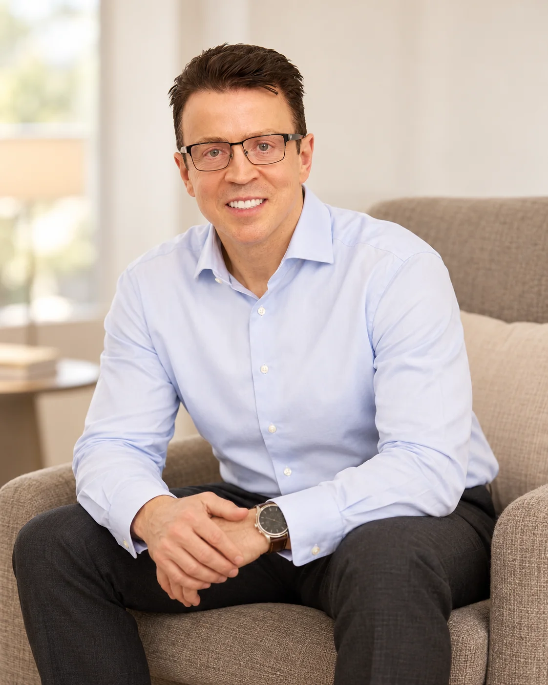 Russell Hammond seated in a warm office setting